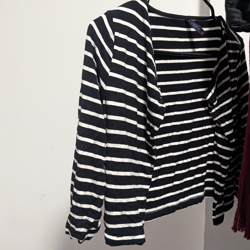 Black shrug with white stripes.
